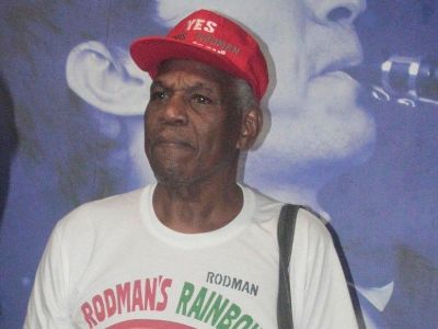 Philander Rodman is wearing a white tee and a red cap in the picture.